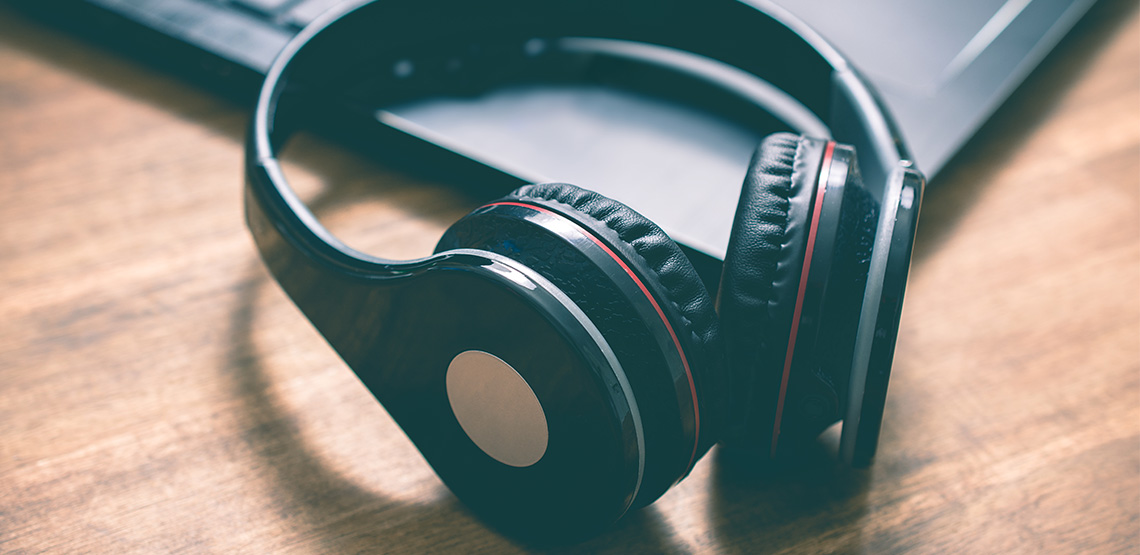 Wireless headphones sitting on a laptop