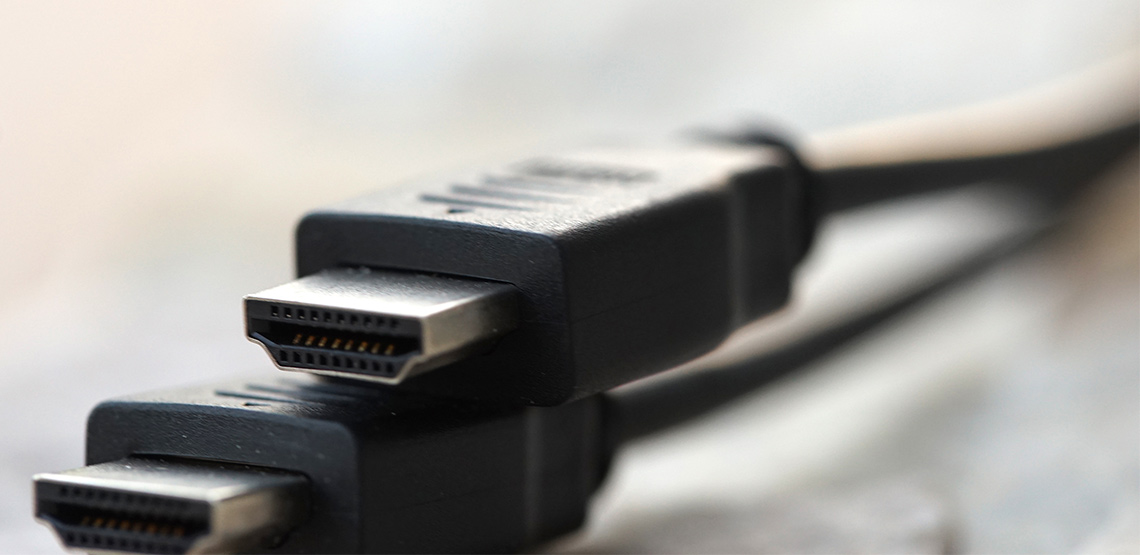 Two HDMI cables sitting on table