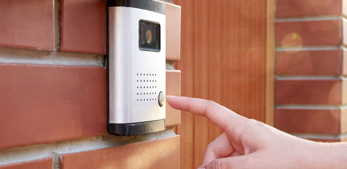 Someone reaching to ring doorbell