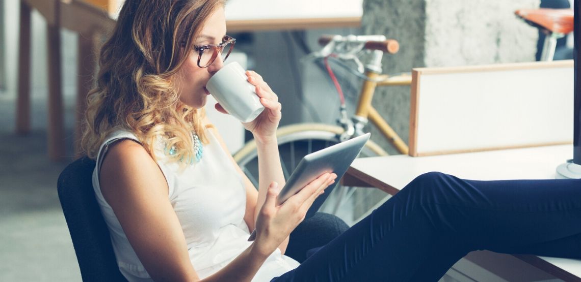 A lady is browsing through her Kindle Unlimited library.