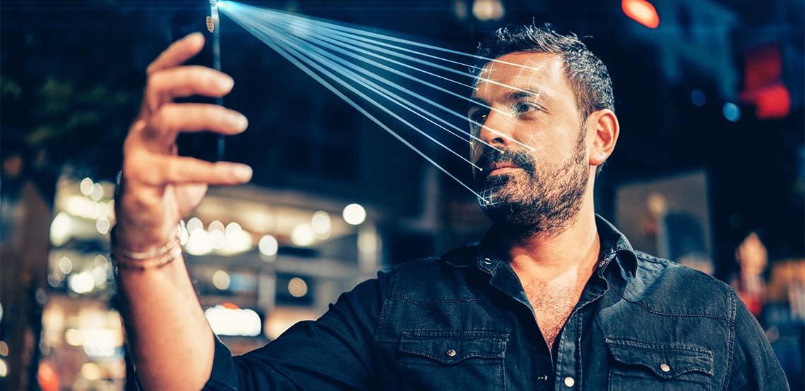 Someone using face recognition to unlock their phone.