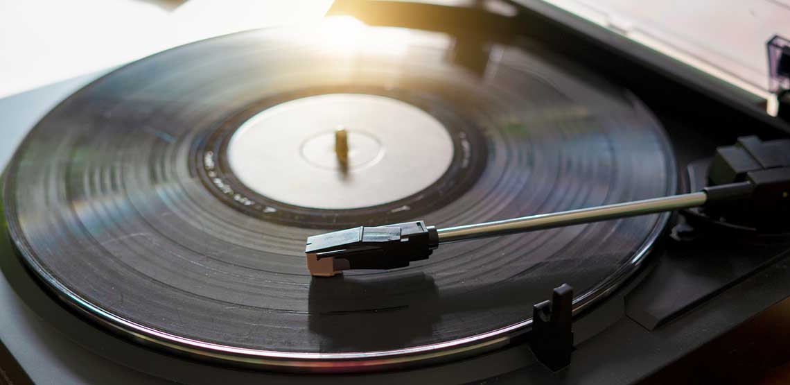 A black record on a record player.