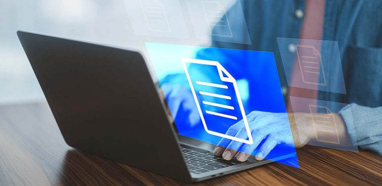 A person typing on a laptop with a holographic blue image of a document floating above.